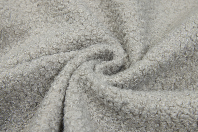 Close-up of light gray fleece sweatshirt fabric gathered in folds