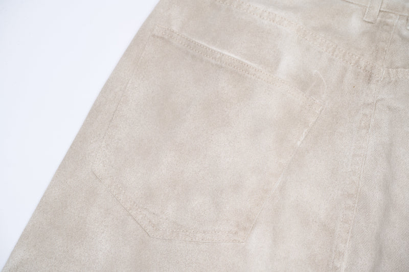 Close-up of beige cargo pants back pocket stitching and seam detail
