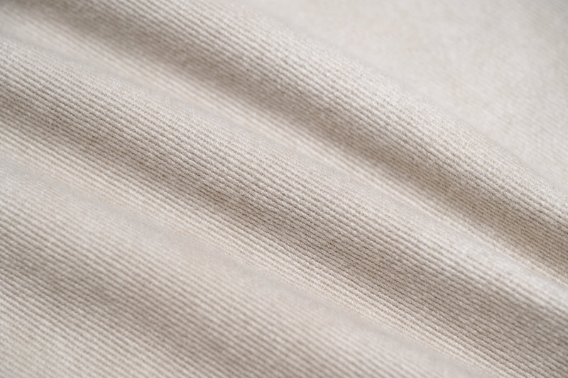 Close-up of beige cotton twill fabric with diagonal weave texture