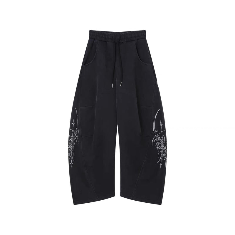 Black wide-leg pants with drawstring waist and white gothic vine graphics on the legs