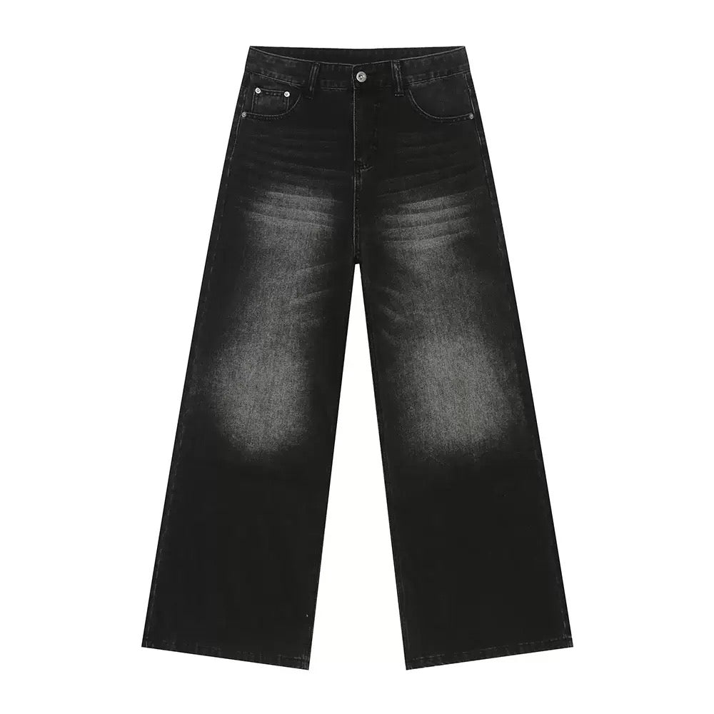 Washed black oversized wide-leg denim jeans with gradient fading and five-pocket design, laid flat on white background