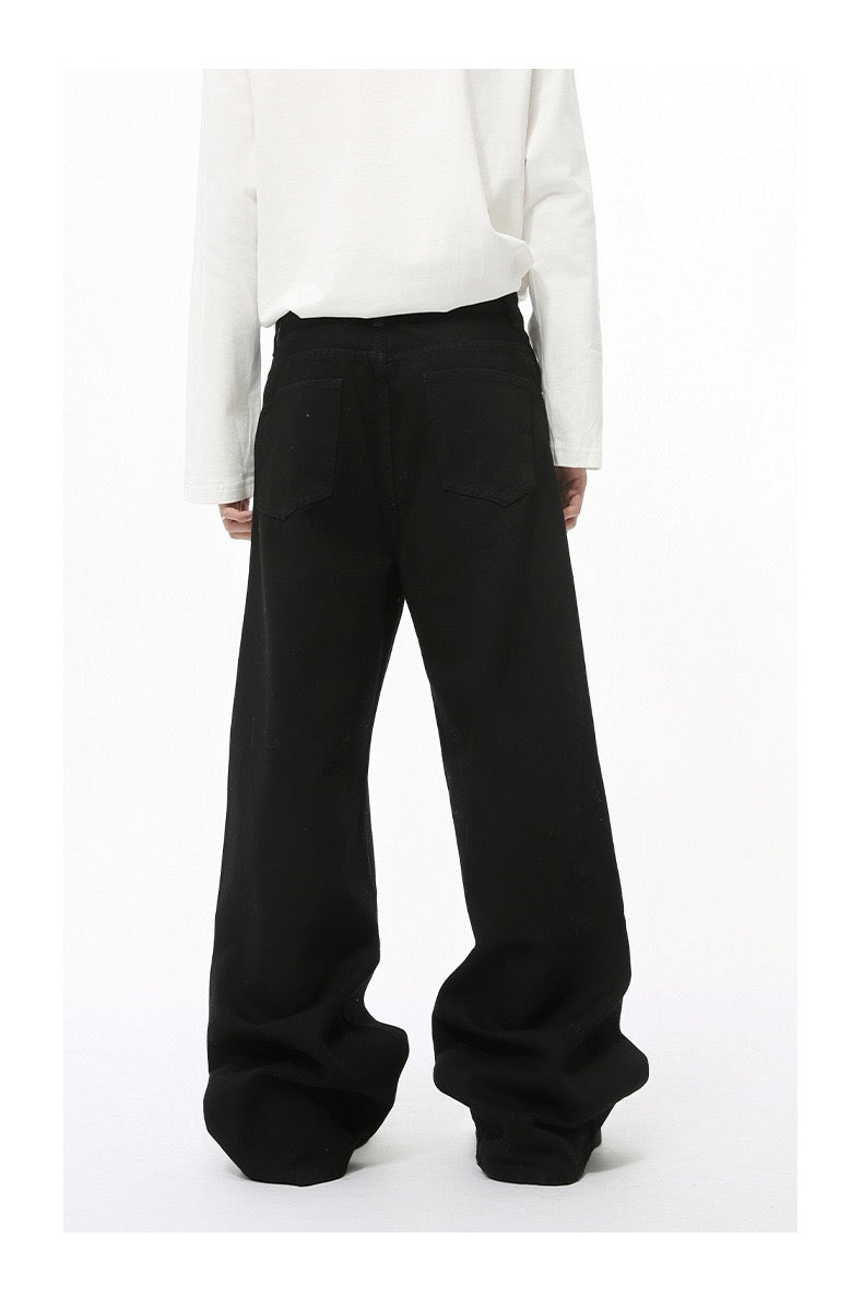 Solid black wide-leg jeans worn by model, back view