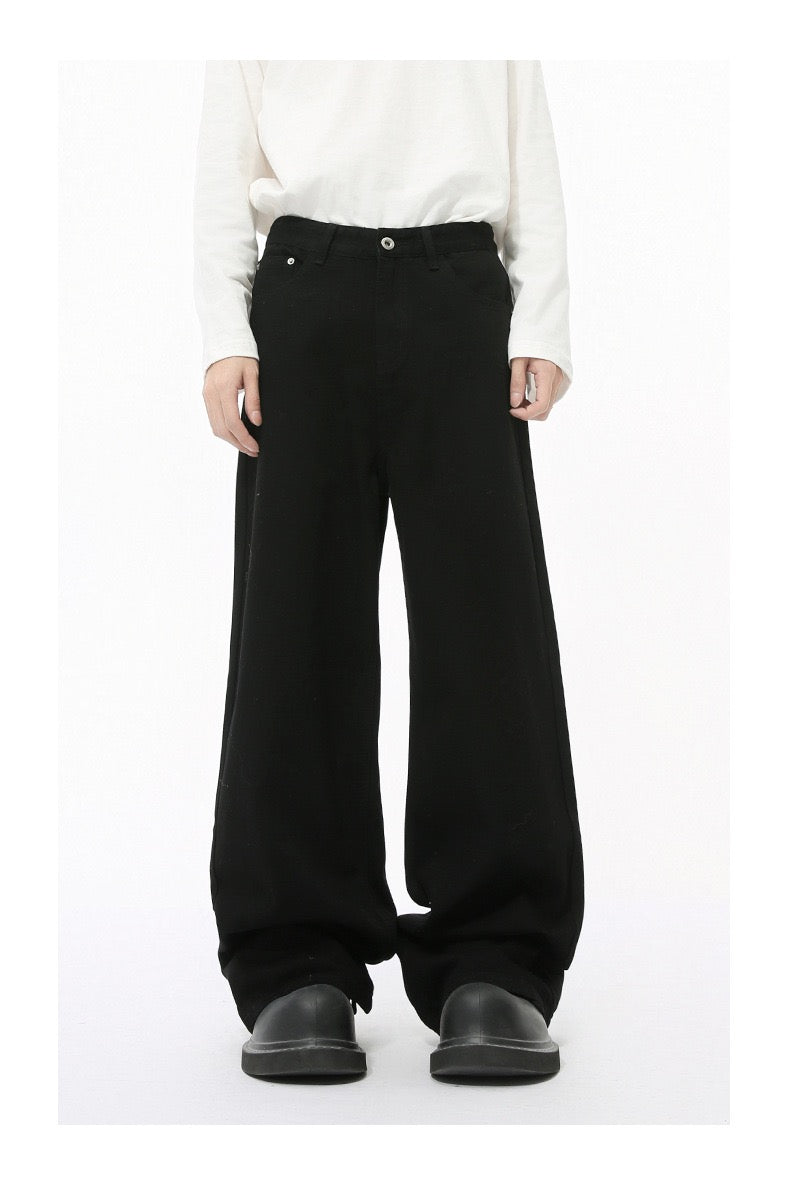 Solid black wide-leg jeans worn by model, front view