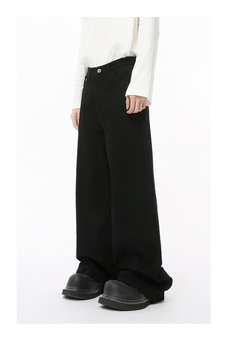 Solid black wide-leg jeans worn by model, angled side view