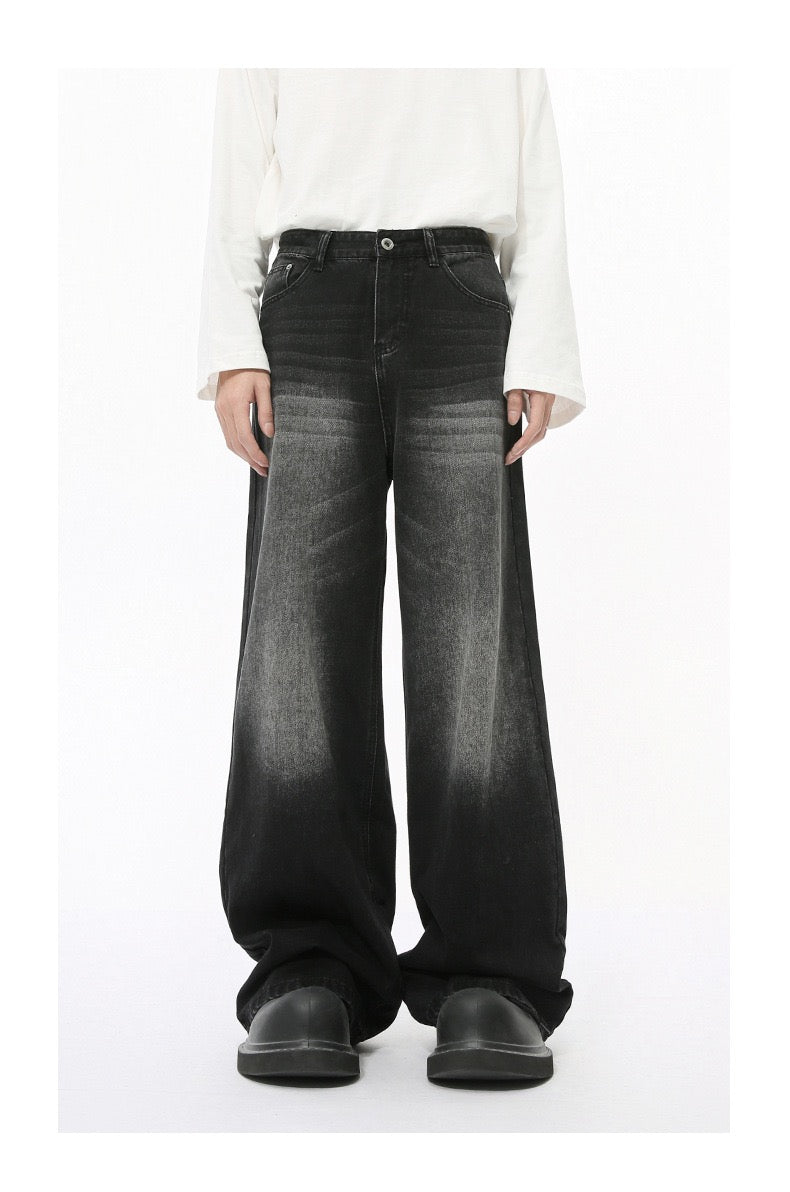 Black wide-leg jeans with faded wash worn by model, front view