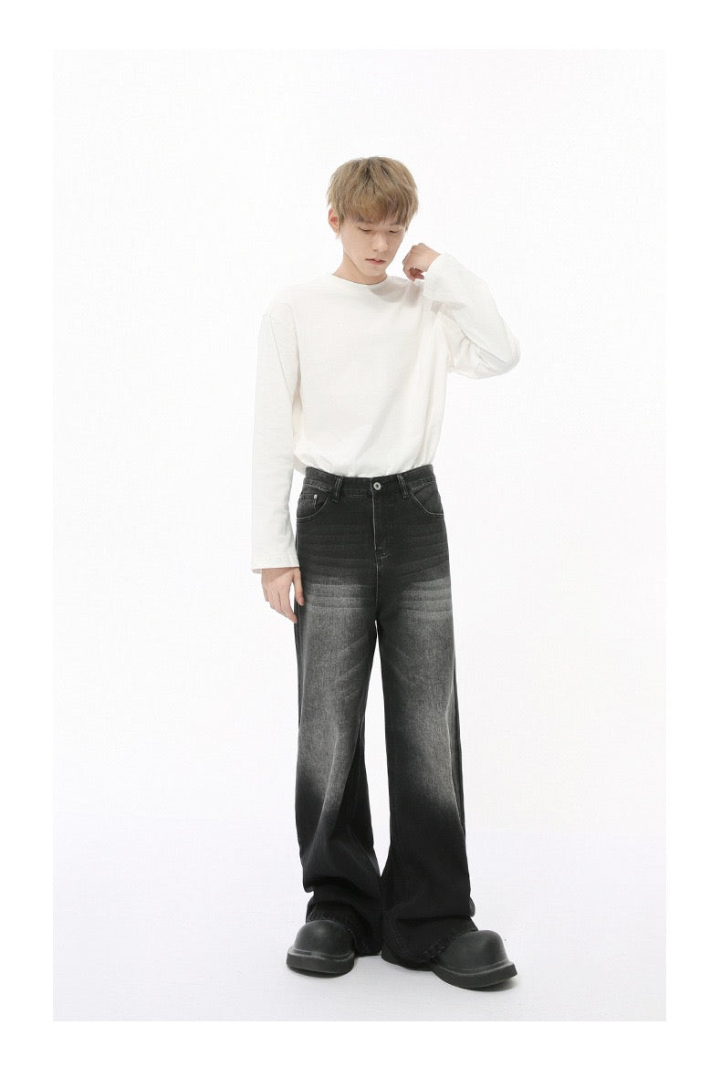 Black wide-leg jeans with faded wash worn by model, full-body front view