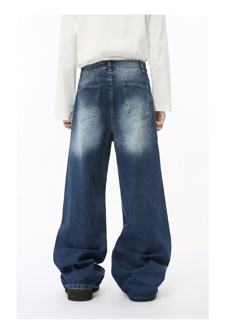 Dark blue wide-leg jeans with faded wash worn by model, back view