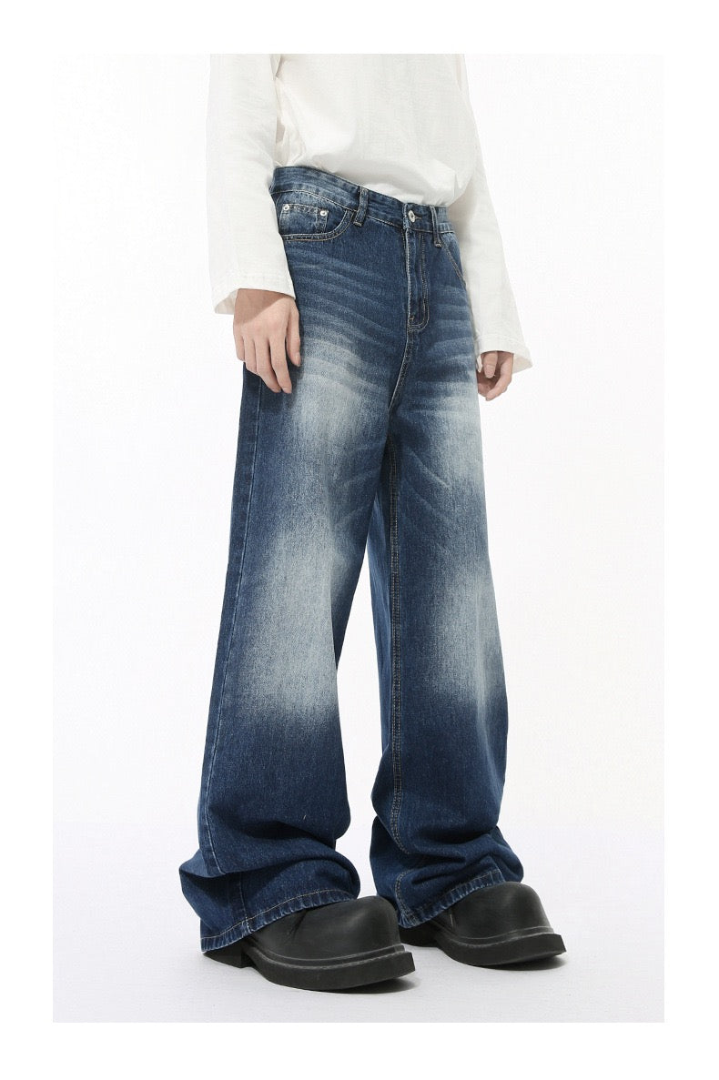 Dark blue wide-leg jeans with faded wash worn by model, angled front view