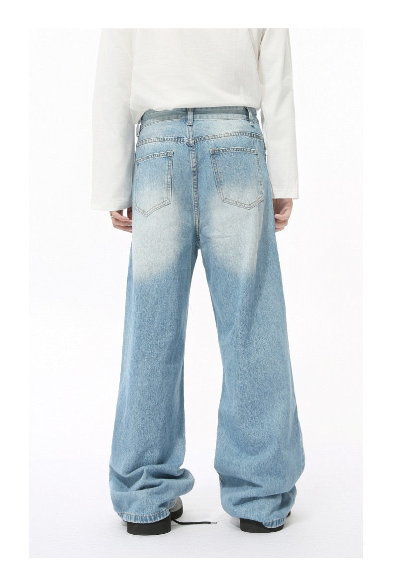 Light blue wide-leg jeans with faded wash worn by model, back view