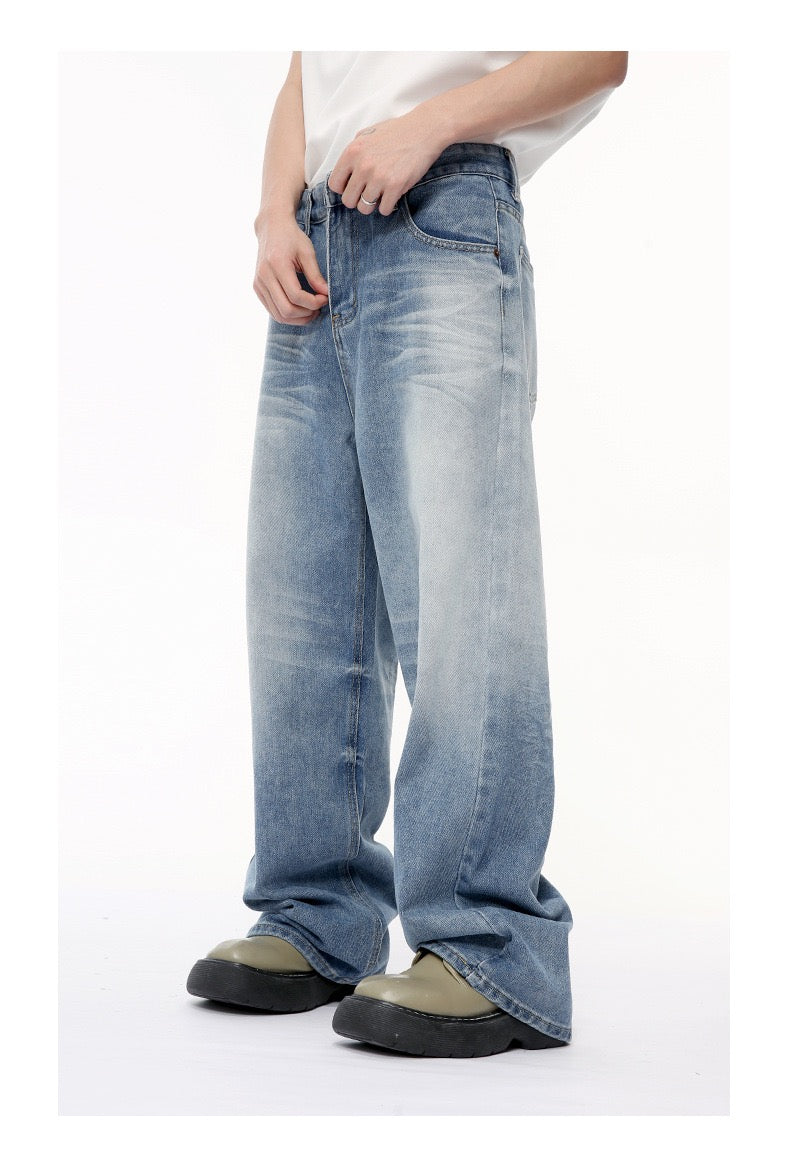 Angled front view of vintage wash wide-leg jeans with light fade on the thighs