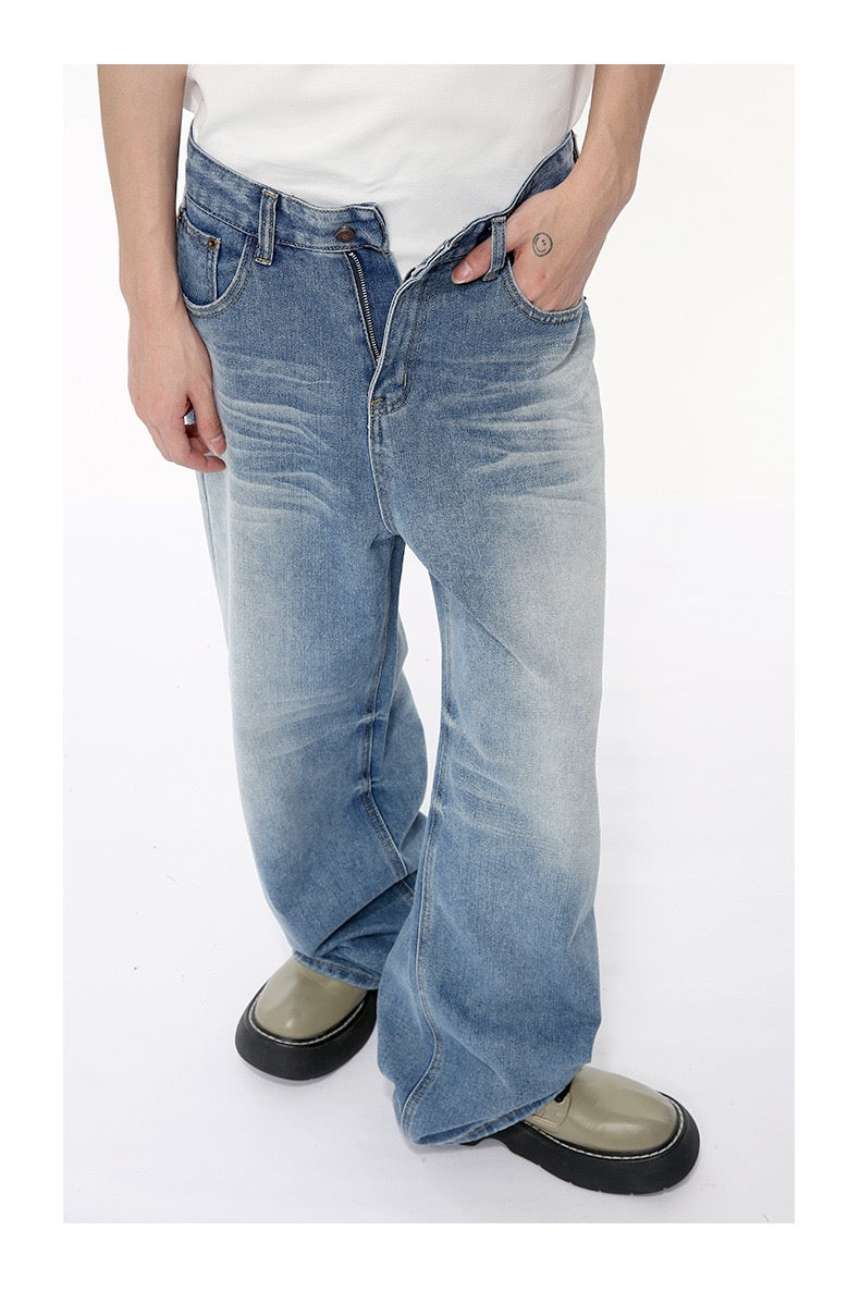 Front view of light blue wide-leg jeans with faded whiskering and olive shoes