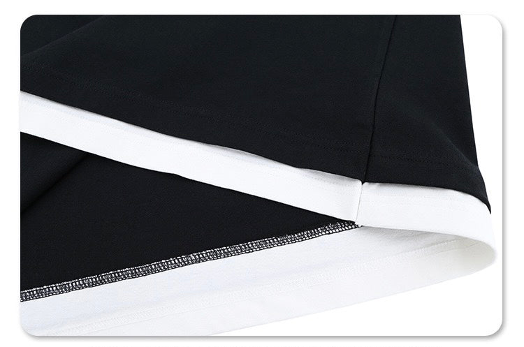 Close-up of black soccer jersey shirt with white trim and hem detail, featuring a sleek streetwear football tee design