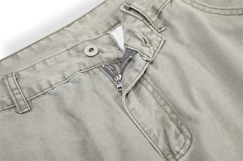 Close-up of light gray pants front waistband with zipper fly and button