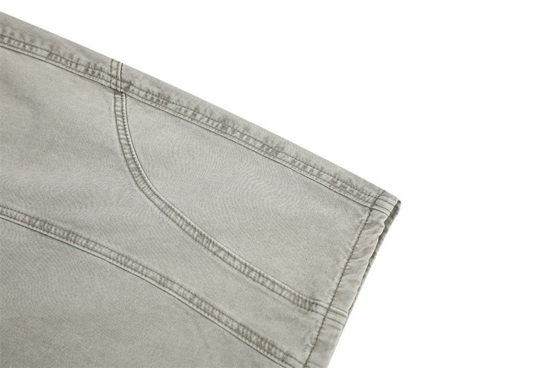Close-up of light gray pants hem and stitched panel seam