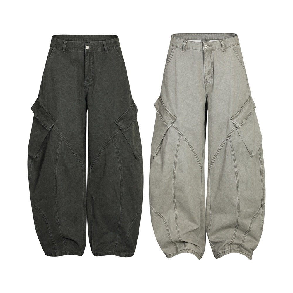 Dark olive and washed sage curved-panel cargo wide-leg pants with flap pockets and balloon silhouette, front view