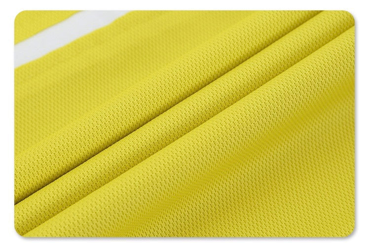 Close-up of bright yellow mesh fabric with textured diagonal folds, showing the retro sport oversized T-shirt material