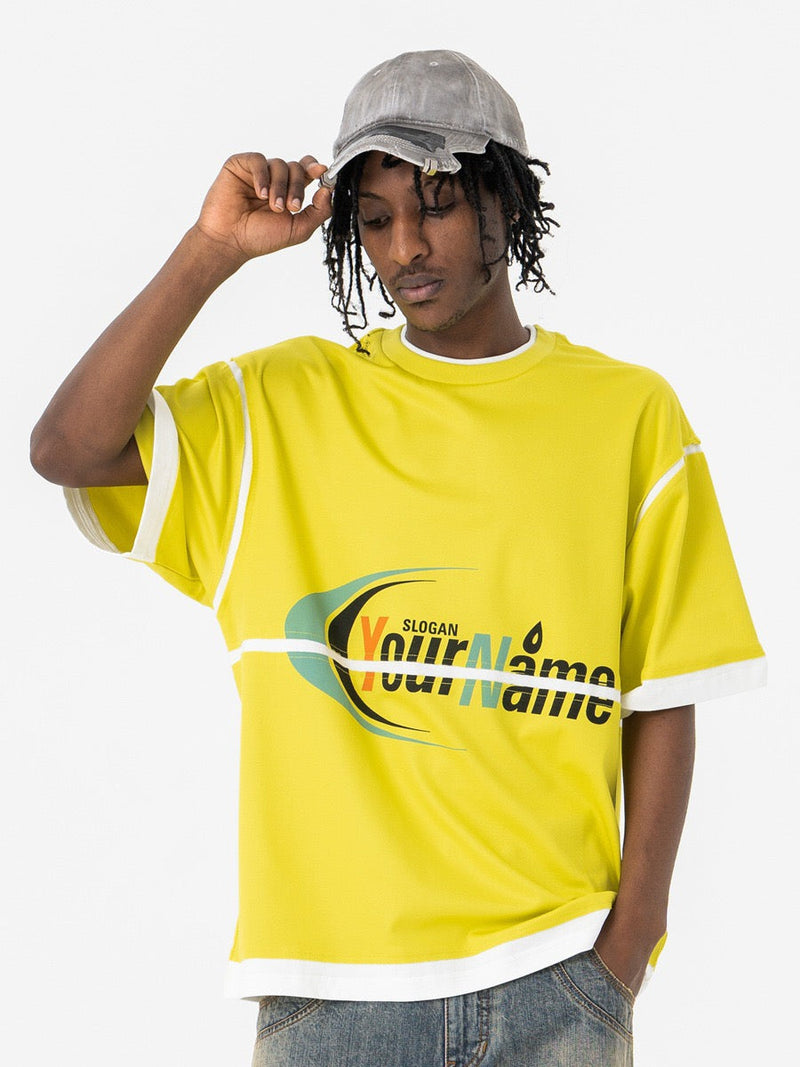 Man wearing a bright yellow oversized graphic T-shirt with white trim and a relaxed streetwear look