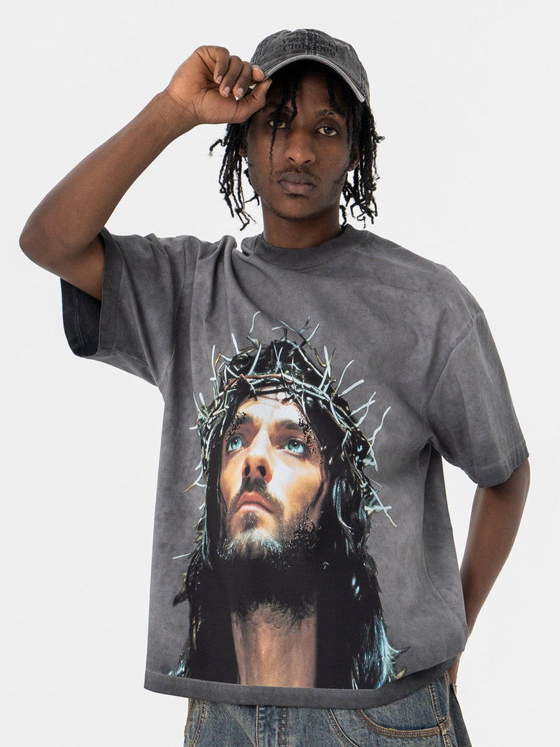 Washed gray oversized graphic tee with crown of thorns portrait print worn by a model in a relaxed streetwear fit