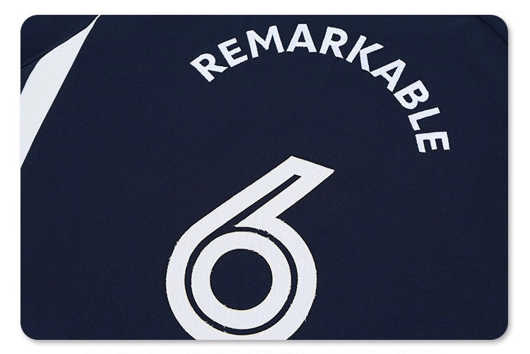Oversized navy varsity jersey tee with Remarkable arched lettering and large white number 6 graphic