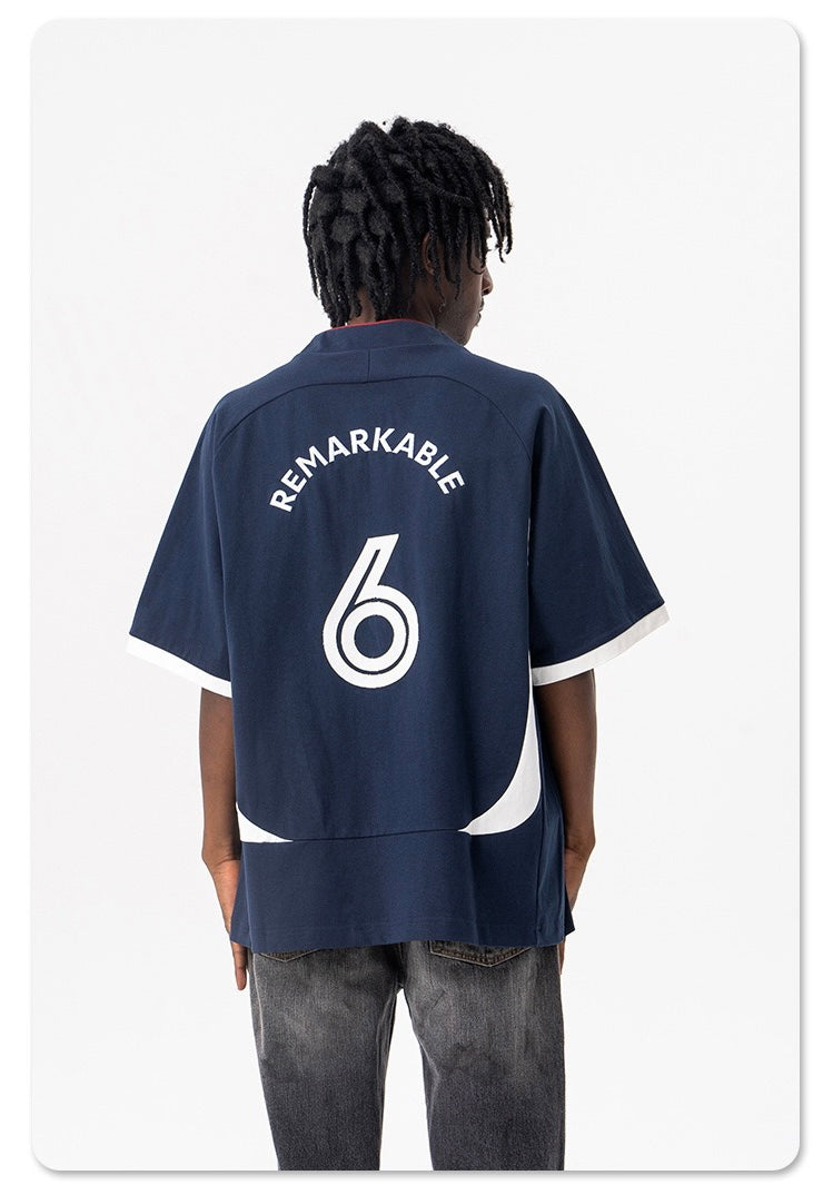 Oversized navy varsity jersey tee with white trim and back number 6, shown on a model from behind