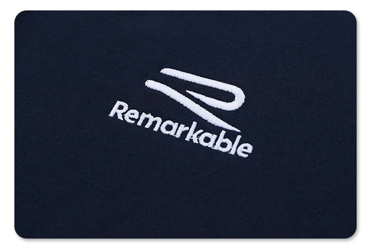 Navy oversized football tee with embroidered Remarkable crest logo on chest