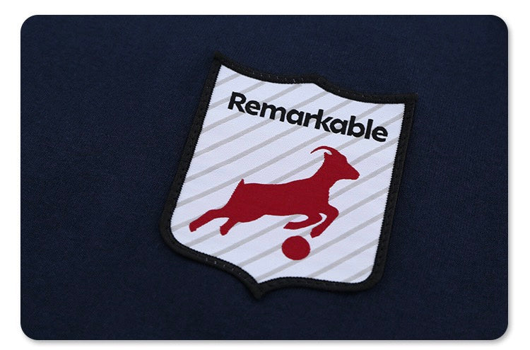 Navy oversized varsity football tee with a retro crest patch and red bull graphic on the chest