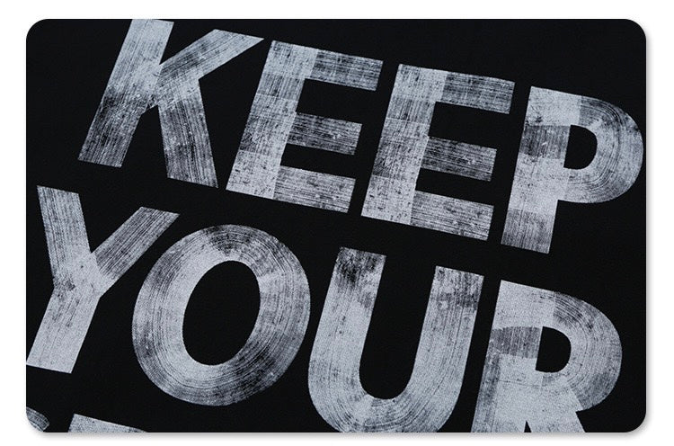 Black oversized graphic tee with bold distressed Keep Your Spirit Free lettering in large white text