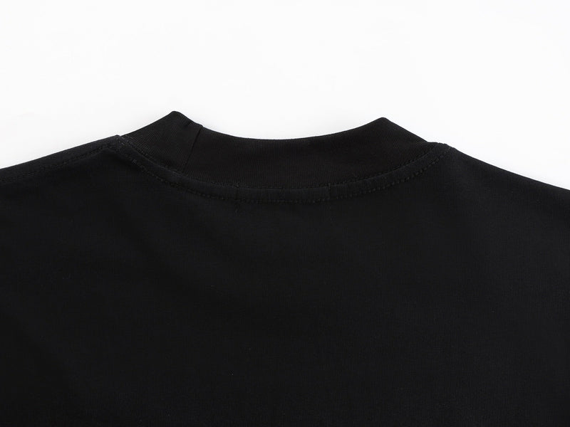 Black oversized graphic tee with a ribbed crew neck and visible seam detailing against a white background