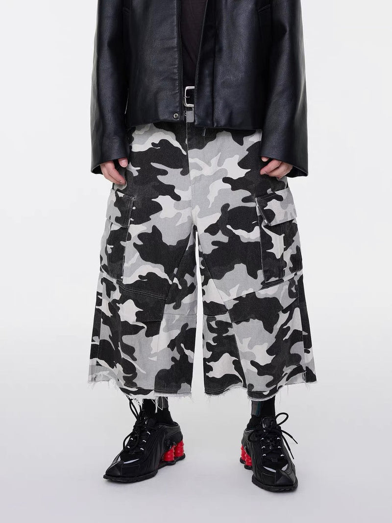 Front view of camo cargo shorts showing wide legs and large flap pockets