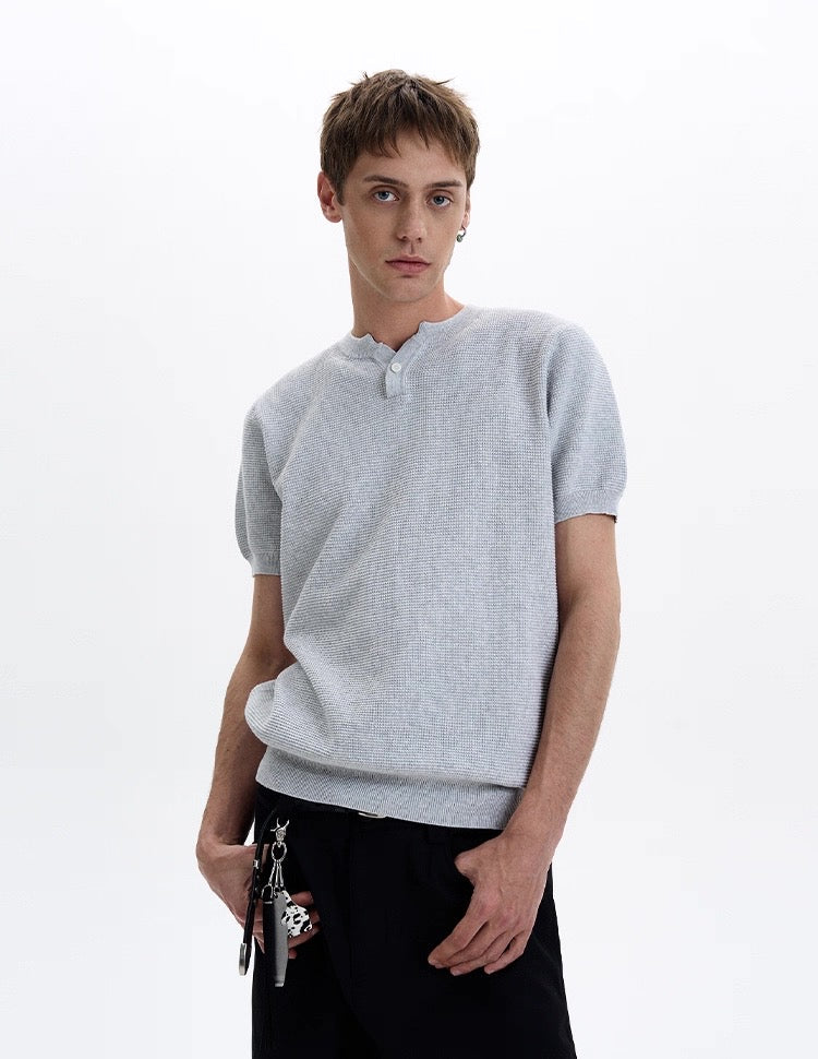 Light gray textured knit short sleeve polo tee with button placket, worn by a male model on a white background