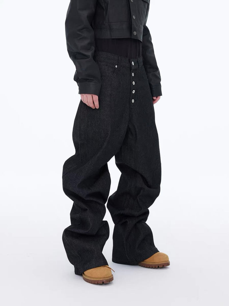 Side view of black wide-leg jeans worn with a cropped jacket