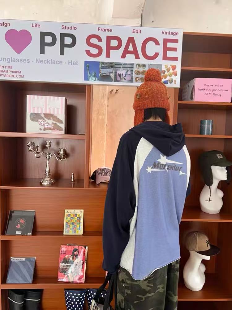 Back view of blue and navy colorblock raglan hoodie with printed logo graphic