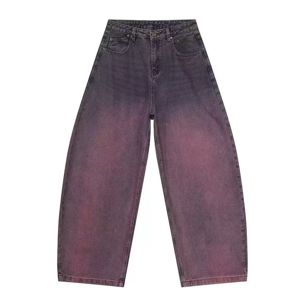 Flat lay of oversized wide-leg jeans with purple to rose gradient wash, high-rise waist and 5-pocket design