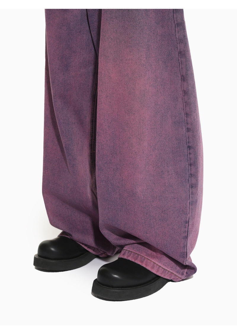 Close-up of purple washed wide-leg jean legs and black shoes at the hem