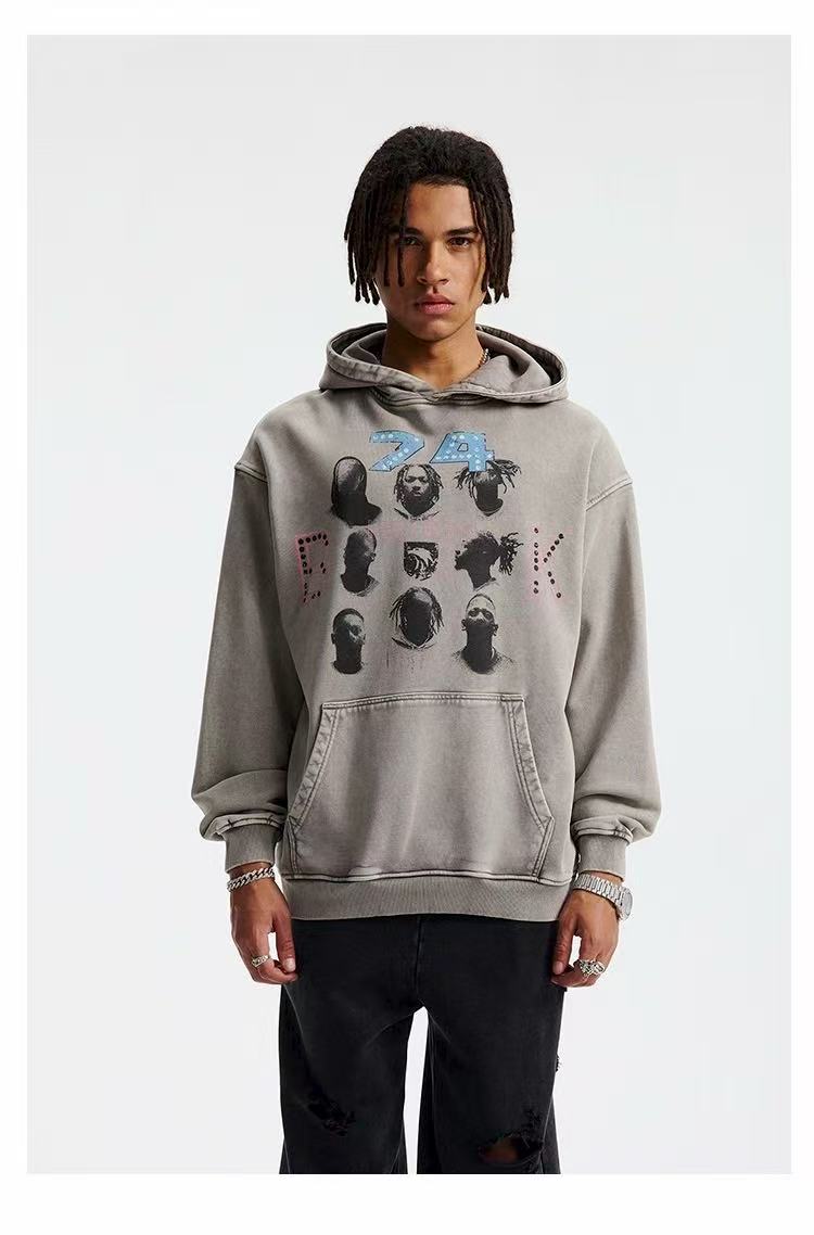 Model wearing gray washed graphic hoodie with hood up and front kangaroo pocket