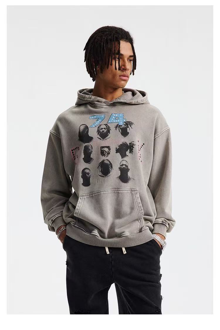 Model in gray washed graphic hoodie shown at a slight left angle, hands in pockets