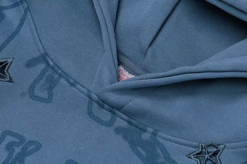 Blue hoodie collar close-up with stitched seam and printed graphic detail