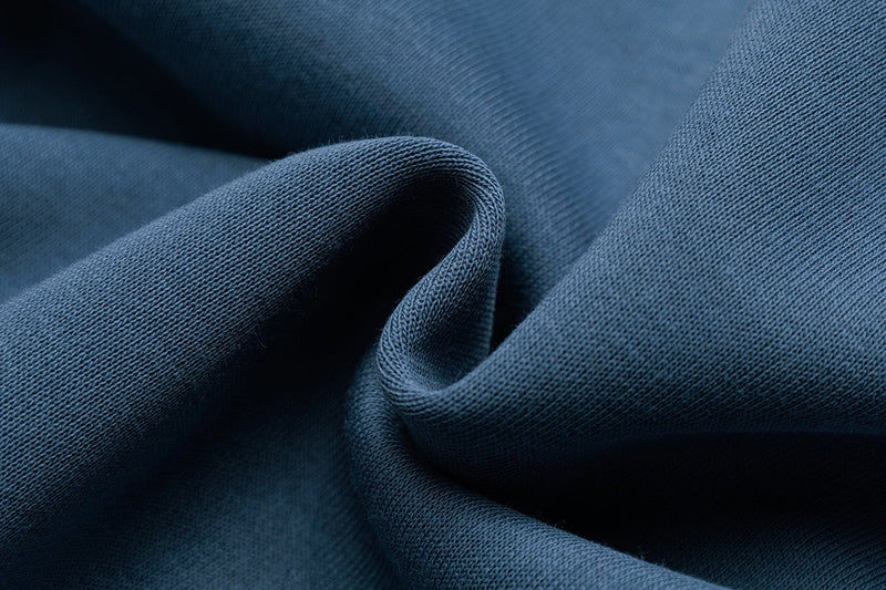 Blue hoodie fabric close-up with soft knit texture and folds