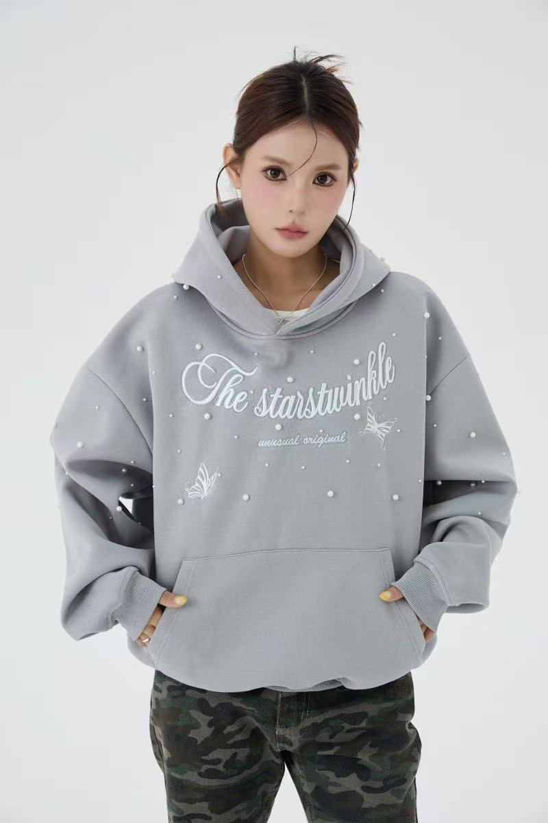 Gray pearl embellished hoodie worn by model, front view with hands in pockets