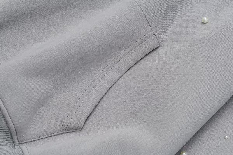 Close-up of gray hoodie side seam and kangaroo pocket