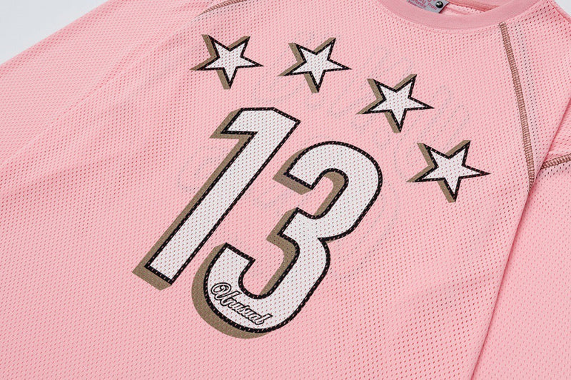 Close-up of pink mesh jersey front graphic with stars and large 13 print