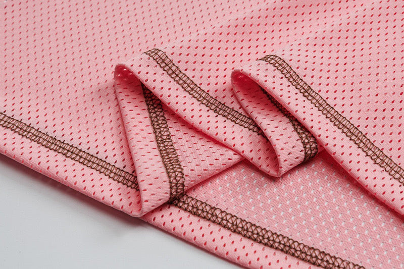 Close-up of pink mesh jersey hem stitching and seam details