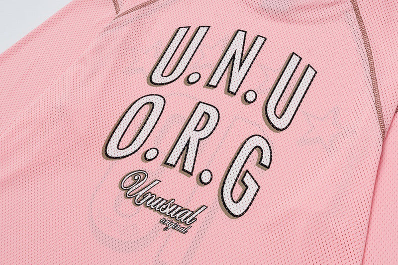 Close-up of pink mesh jersey back print with U.N.U O.R.G and Unusual original