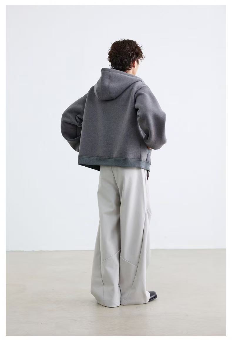Back view of model wearing gray oversized hoodie and wide-leg pants