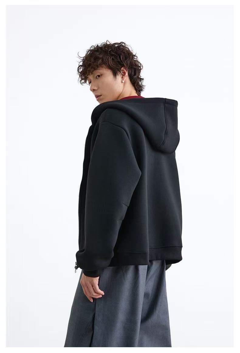Side back view of black oversized hoodie with hood up
