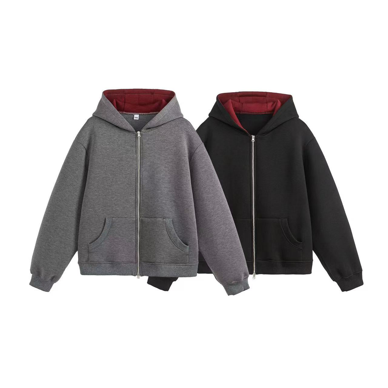 Grey and black oversized zip-up hoodies with burgundy contrast inner hood lining, displayed flat on white background