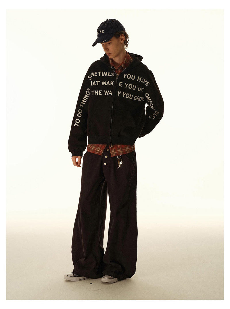 Black oversized hoodie worn open with white slogan print