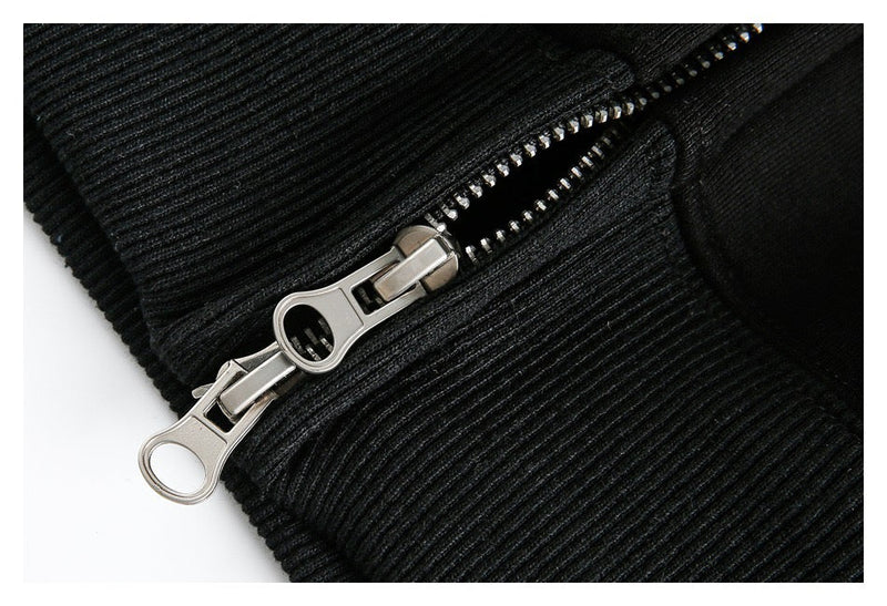 Close-up of black hoodie zipper pull and ribbed trim