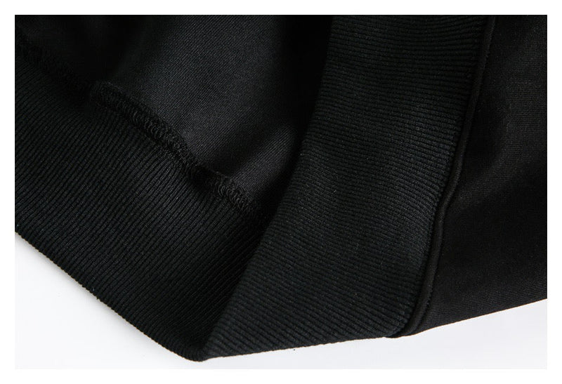 Close-up of black hoodie ribbed cuff and hem seam