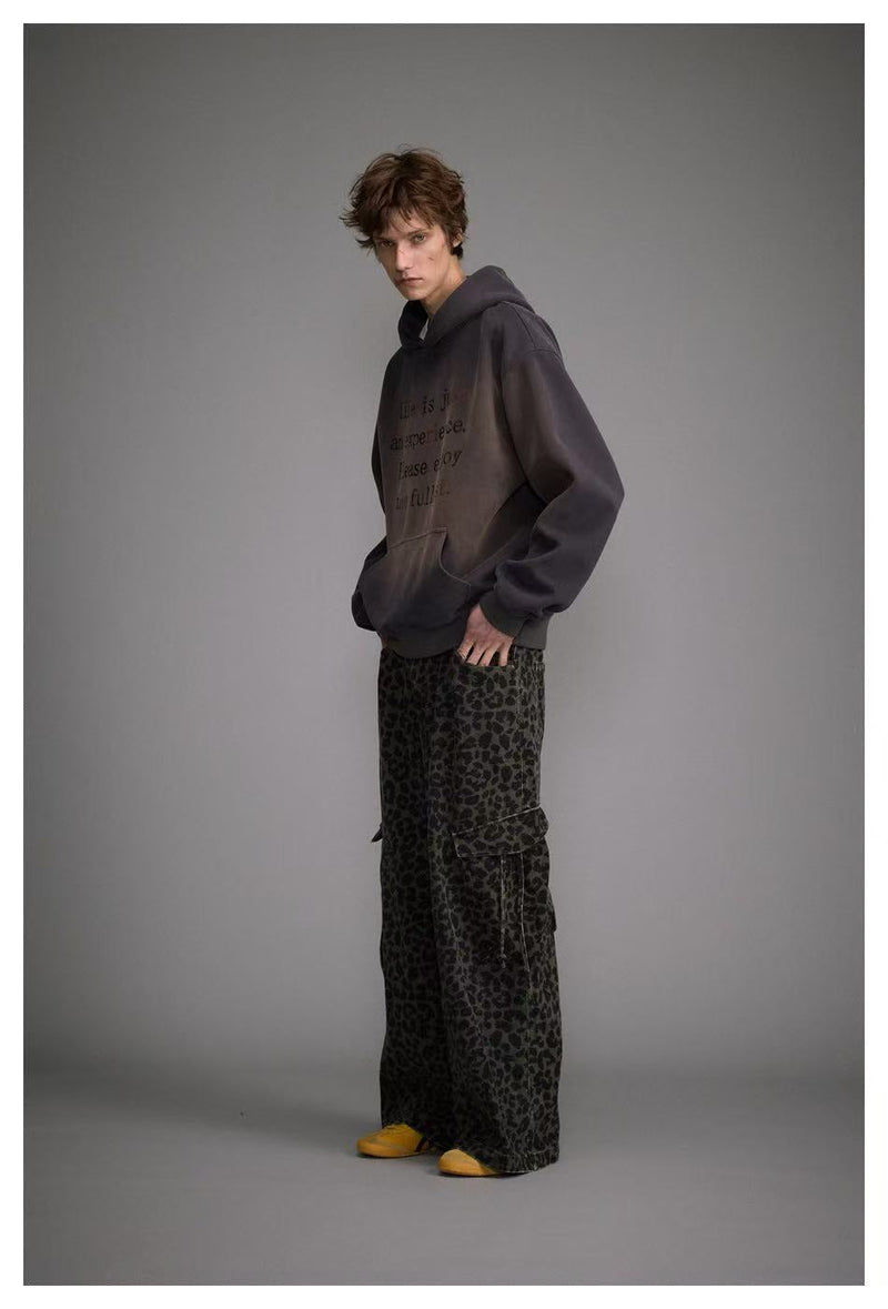 Side view of model wearing dark washed oversized hoodie with graphic print